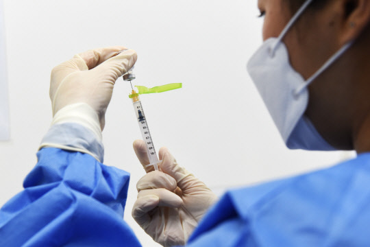 3일 중부권역 코로나19 예방접종센터인 충남 천안 실내배드민턴장에서 의료인이 화이자 백신을 주사기에 넣고 있다.  [순천향대 천안병원 제공]